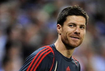 BARCELONA, SPAIN - AUGUST 02:  Xabi Alonso of Liverpool smiles during his warm up reacting to shouts from fans regarding his possible move to Real Madrid during the pre-season friendly match between Espanyol and Liverpool at the Nuevo Estadio de Cornella-El Prat on August 2, 2009 in Barcelona, Spain. Espanyol won the match 3-0.  (Photo by Jasper Juinen/Getty Images)