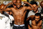 LAS VEGAS - SEPTEMBER 18:  Boxer Floyd Mayweather Jr. (L) poses as his opponent Juan Manuel Marquez checks the scale during their official weigh-in at the MGM Grand Garden Arena September 18, 2009 in Las Vegas, Nevada. The two will fight at the MGM on September 19.  (Photo by Ethan Miller/Getty Images)