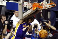 AUBURN HILLS, MI - JUNE 15: Kobe Bryant #8 of the Los Angeles Lakers hangs from the rim after dunking the basketball while defended by Lindsey Hunter #10 of the Detroit Pistons during the second quarter in Game five of the 2004 NBA Finals on June 15, 2004 at The Palace of Auburn Hills in Auburn Hills, Michigan. NOTE TO USER: User expressly acknowledges and agrees that, by downloading and or using this photograph, User is consenting to the terms and conditions of the Getty Images License Agreement. (Photo by Tom Pidgeon/Getty Images)