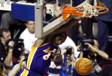 AUBURN HILLS, MI - JUNE 15:  Kobe Bryant #8 of the Los Angeles Lakers hangs from the rim after dunking the basketball while defended by Lindsey Hunter #10 of the Detroit Pistons during the second quarter in Game five of the 2004 NBA Finals on June 15, 2004 at The Palace of Auburn Hills in Auburn Hills, Michigan.  NOTE TO USER: User expressly acknowledges and agrees that, by downloading and or using this photograph, User is consenting to the terms and conditions of the Getty Images License Agreement.  (Photo by Tom Pidgeon/Getty Images)