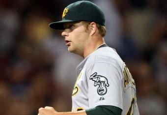 BOSTON - JULY 06:  Starting pitcher Brett Anderson #49 of the Oakland Athletics celebrates his shutout against the Boston Red Sox on July 6, 2009 at Fenway Park in Boston, Massachusetts. The Athletics defeated the Red Sox 6-0. (Photo by Elsa/Getty Images)