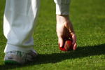 LONDON, ENGLAND - APRIL 22:  A fielder picks up the ball during day one of the LV County Championship Division 2 match between Middlesex and Glamorgan at Lords on April 22, 2009 in London, England.  (Photo by Ryan Pierse/Getty Images)