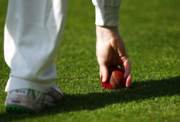 LONDON, ENGLAND - APRIL 22:  A fielder picks up the ball during day one of the LV County Championship Division 2 match between Middlesex and Glamorgan at Lords on April 22, 2009 in London, England.  (Photo by Ryan Pierse/Getty Images)