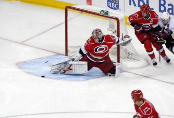 RALEIGH, NC - MAY 26:  Goalie Cam Ward #30 of the Carolina Hurricanes deflects the puck against the Pittsburgh Penguins during Game Four of the Eastern Conference Championship Round of the 2009 Stanley Cup Playoffs at RBC Center on May 26, 2009 in Raleigh, North Carolina.   (Photo by Kevin C. Cox/Getty Images)