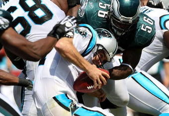 CHARLOTTE, NC - SEPTEMBER 13:  Quarterback Jake Delhomme #17 of the Carolina Panthers is sacked by Linebacker Jordan Akeem #56, of the Philadelphia Eagles in the first half of the NFL season opener at Bank of America Stadium on September 13, 2009 in Charlotte, North Carolina.  (Photo by Streeter Lecka/Getty Images)