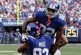 EAST RUTHERFORD, NJ - SEPTEMBER 13:  Mario Manningham #82 of the New York Giants celebrates his second quarter touchdown against the Washington Redskins with teammate Sinorice Moss #83 on September 13, 2009 at Giants Stadium in East Rutherford, New Jersey.  (Photo by Jim McIsaac/Getty Images)