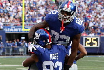 EAST RUTHERFORD, NJ - SEPTEMBER 13:  Mario Manningham #82 of the New York Giants celebrates his second quarter touchdown against the Washington Redskins with teammate Sinorice Moss #83 on September 13, 2009 at Giants Stadium in East Rutherford, New Jersey.  (Photo by Jim McIsaac/Getty Images)