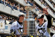 PITTSBURGH - JUNE 15:  Marc-Andre Fleury #29 and Sidney Crosby #87 of the Pittsburgh Penguins show off the Stanley Cup to the crowd on the Blvd of the Allies during the Stanley Cup Champion Victory Parade on June 15, 2009 in Pittsburgh, Pennsylvania.  (Photo by Jamie Sabau/Getty Images)