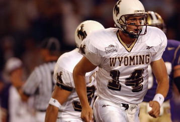 SEATTLE - SEPTEMBER 21:  Quarterback Casey Bramlet #14 of the Wyoming Cowboys runs on the field during the NCAA football game against the Washington Huskies on September 21, 2002 at Husky Stadium in Seattle, Washington.  The Huskies won 38-7.  (Photo by Otto Greule Jr/Getty Images)