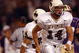 SEATTLE - SEPTEMBER 21:  Quarterback Casey Bramlet #14 of the Wyoming Cowboys runs on the field during the NCAA football game against the Washington Huskies on September 21, 2002 at Husky Stadium in Seattle, Washington.  The Huskies won 38-7.  (Photo by Otto Greule Jr/Getty Images)