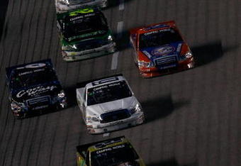 FT. WORTH , TX - JUNE 05:  A pack of trucks race during the NASCAR Camping World Truck Series Winstar World Casino 400 on June 5, 2009 at Texas Motor Speedway in Ft. Worth, Texas.  (Photo by Jonathan Ferrey/Getty Images)
