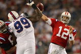FOXBORO, MA - SEPTEMBER 14:  Tom Brady #12 of the New England Patriots passes the ball as Marcus Stroud #99 of the Buffalo Bills defends on September 14, 2009 at Gillette Stadium in Foxboro, Massachusetts. The Patriots defeated the Bills 25-24.  (Photo by Elsa/Getty Images)