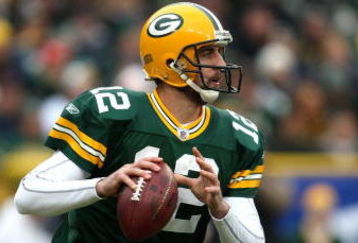 GREEN BAY, WI - NOVEMBER 30:  Aaron Rodgers #12 of the Green Bay Packers rolls out to pass against the Carolina Panthers at Lambeau Field on November 30, 2008 in Green Bay, Wisconsin. The Panthers won 35-31. (Photo by Jonathan Daniel/Getty Images)