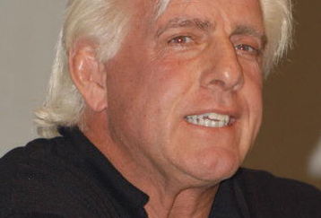 GARDEN CITY, NY - MARCH 3:  World Wrestling Entertainment (WWE) professional wrestler Ric Flair speaks on a panel during the 'Professor For A Day' event at Nassau Community College March 3, 2003 in Garden City, New York. Flair acted as an assistant professor to WWE CEO Linda McMahon, who lectured a group of sports marketing majors on the marketing and promotional strategies that have made the WWE a long-term success.  (Photo By Steven Henry/Getty Images)