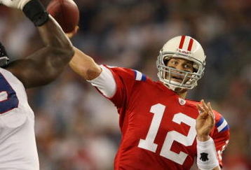 FOXBORO, MA - SEPTEMBER 14:  Tom Brady #12 of the New England Patriots passes the ball as Marcus Stroud #99 of the Buffalo Bills defends on September 14, 2009 at Gillette Stadium in Foxboro, Massachusetts. The Patriots defeated the Bills 25-24.  (Photo by Elsa/Getty Images)