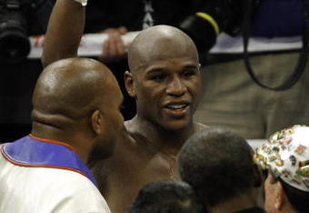 LAS VEGAS - SEPTEMBER 19:  Floyd Mayweather Jr. (L) celebrates his unanimous decision victory over Juan Manuel Marquez during their bout at the MGM Grand Garden Arena September 19, 2009 in Las Vegas, Nevada.  (Photo by Eric Jamison/Getty Images)