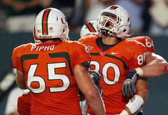 FORT LAUDERDALE, FL - SEPTEMBER 17:  Tight end Jimmy Graham #80 of the Miami Hurricanes celebrates his touchdown catch with offensive linemen Matt Pipho #65 and Jason Fox #64 against the Georgia Tech Yellow Jackets at Land Shark Stadium on September 17, 2009 in Fort Lauderdale, Florida. Miami defeated Georgia Tech 33-17.  (Photo by Doug Benc/Getty Images)