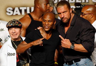 LAS VEGAS - SEPTEMBER 18:  (L-R) Cornerman Rafael Garcia, boxer Floyd Mayweather Jr. and WWE wrestler Triple H pose during the official weigh-in for Mayweather's fight against Juan Manuel Marquez at the MGM Grand Garden Arena September 18, 2009 in Las Vegas, Nevada. The two will fight at the MGM on September 19.  (Photo by Ethan Miller/Getty Images)