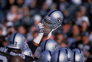 4 Aug 2001:  A player of the Oakland Raiders holds up his helmet during the Pre-Season game against the Dallas Cowboys at the network Associates Coliseum in Oakland, California. The Raiders defeated the Cowboys 21-14.Mandatory Credit: Jed Jacobsohn  /Allsport