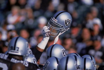 4 Aug 2001:  A player of the Oakland Raiders holds up his helmet during the Pre-Season game against the Dallas Cowboys at the network Associates Coliseum in Oakland, California. The Raiders defeated the Cowboys 21-14.Mandatory Credit: Jed Jacobsohn  /Allsport