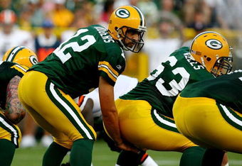 GREEN BAY, WI - AUGUST 15:  Quarterback Aaron Rodgers #12 of the Green Bay Packers waits for the snap behind center Scott Wells #63 against the Cleveland Browns during the preseason game at Lambeau Field on August 15, 2009 in Green Bay, Wisconsin.  (Photo by Jonathan Daniel/Getty Images)