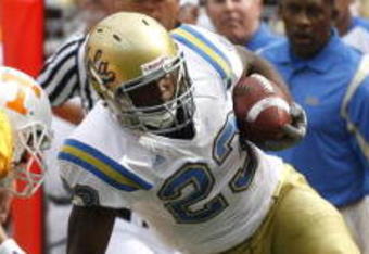 KNOXVILLE, TN - SEPTEMBER 12: Jonathan Franklin #23 of the UCLA Bruins is knocked out of bounds by Janzen Jackson #15 and Dennis Rogan #41 of the Tennessee Volunteers on September 12, 2009 at Neyland Stadium in Knoxville, Tennessee. UCLA beat Tennessee 19-15. (Photo by Joe Murphy/Getty Images)