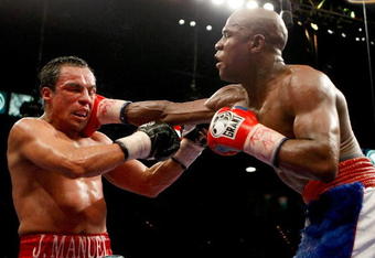 LAS VEGAS - SEPTEMBER 19:  Floyd Mayweather Jr. (R) hits Juan Manuel Marquez in the 11th round of their fight at the MGM Grand Garden Arena September 19, 2009 in Las Vegas, Nevada. Mayweather won by unanimous decision.  (Photo by Ethan Miller/Getty Images)