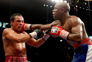 LAS VEGAS - SEPTEMBER 19:  Floyd Mayweather Jr. (R) hits Juan Manuel Marquez in the 11th round of their fight at the MGM Grand Garden Arena September 19, 2009 in Las Vegas, Nevada. Mayweather won by unanimous decision.  (Photo by Ethan Miller/Getty Images)