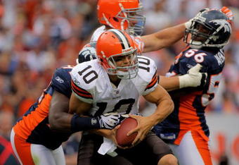 DENVER - SEPTEMBER 20:  Quarterback Brady Quinn #10 of the Cleveland Browns is sacked by defensive end Elvis Dumervil #92 of the Denver Broncos in the fourth quarter during NFL action at Invesco Field at Mile High on September 20, 2009 in Denver, Colorado. The Broncos defeated the Browns 27-6.  (Photo by Doug Pensinger/Getty Images)