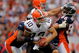 DENVER - SEPTEMBER 20:  Quarterback Brady Quinn #10 of the Cleveland Browns is sacked by defensive end Elvis Dumervil #92 of the Denver Broncos in the fourth quarter during NFL action at Invesco Field at Mile High on September 20, 2009 in Denver, Colorado. The Broncos defeated the Browns 27-6.  (Photo by Doug Pensinger/Getty Images)
