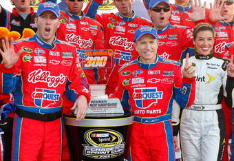 LOUDON, NH - SEPTEMBER 20:  Mark Martin, driver of the #5 CARQUEST/Kellogg's Chevrolet, celebrates with the trophy in victory lane after winning the NASCAR Sprint Cup Series Sylvania 300 at the New Hampshire Motor Speedway on September 20, 2009 in Loudon, New Hampshire.  (Photo by Geoff Burke/Getty Images for NASCAR)