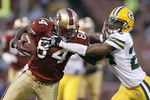 SAN FRANCISCO - AUGUST 16:  Wide receiver Josh Morgan #84 of the San Francisco 49ers stiff arms defensive back Jarrett Bush #24 of the Green Bay Packers during a preseason game at Candlestick Park on August 16, 2008 in San Francisco, California. San Francisco won 34 to 6.  (Photo by Greg Trott/Getty Images)