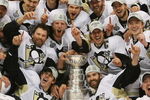 DETROIT - JUNE 12: The Pittsburgh Penguins celebrate with the Stanley Cup following the Penguins victory over the Detroit Red Wings in Game Seven of the 2009 NHL Stanley Cup Finals at Joe Louis Arena on June 12, 2009 in Detroit, Michigan. (Photo by Bruce Bennett/Getty Images)