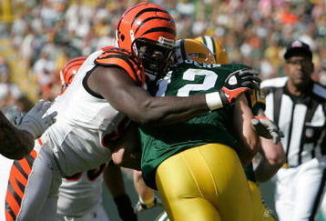 GREEN BAY, WI - SEPTEMBER 20: Quarterback Aaron Rogers #12 of the Green Bay Packers is sacked by defensive end Antwan Odem #98 of the Cincinnati Bengals at Lambeau Field on September 20, 2009 in Green Bay, Wisconsin. The Bengals defeated the Packers 31-24. (Photo by Scott Boehm/Getty Images)