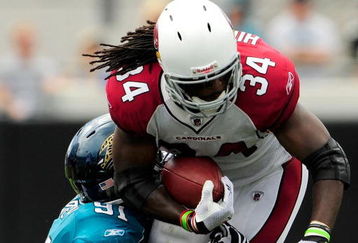 JACKSONVILLE, FL - SEPTEMBER 20:  Tim Hightower #34 of the Arizona Cardinals is tackled by Derrick Harvey #91 of the Jacksonville Jaguars during the game at Jacksonville Municipal Stadium on September 20, 2009 in Jacksonville, Florida.  (Photo by Sam Greenwood/Getty Images)