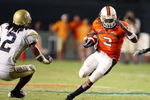 FORT LAUDERDALE, FL - SEPTEMBER 17:  Running back Graig Cooper #2 of the Miami Hurricanes looks to avoid being brought down by cornerback Mario Butler #2 of the Georgia Tech Yellow Jackets at Land Shark Stadium on September 17, 2009 in Fort Lauderdale, Florida. Miami defeated Georgia Tech 33-17.  (Photo by Doug Benc/Getty Images)
