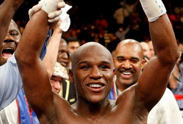 LAS VEGAS - SEPTEMBER 19:  Floyd Mayweather Jr., with his advisor Leonard Ellerbe behind him, celebrates his unanimous-decision victory over Juan Manuel Marquez at the MGM Grand Garden Arena September 19, 2009 in Las Vegas, Nevada.  (Photo by Ethan Miller/Getty Images)