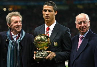 MANCHESTER, UNITED KINGDOM - DECEMBER 10:  Cristiano Ronaldo (C) of Manchester United receives the Ballon d'or as the European Footballer of the Year flanked by previous winners Denis Law (L) and Bobby Charlton before the UEFA Champions League Group E match between Manchester United and Aalborg at Old Trafford on December 10, 2008 in Manchester, England.  (Photo by Alex Livesey/Getty Images)