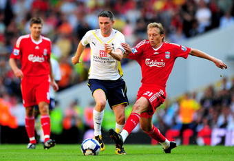 LONDON, ENGLAND - AUGUST 16:  Robbie Keane of Tottenham is challenged by Lucas Leiva of Liverpool during the Barclays Premier League match between Tottenham Hotspur and Liverpool at White Hart Lane on August 16, 2009 in London, England.  (Photo by Mike Hewitt/Getty Images)