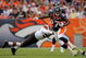 DENVER - SEPTEMBER 20:  Running back Knowshon Moreno #27 of the Denver Broncos eludes a tackle by linebacker David Bowens #96 of the Cleveland Browns during NFL action at Invesco Field at Mile High on September 20, 2009 in Denver, Colorado. The Broncos defeated the Browns 27-6.  (Photo by Doug Pensinger/Getty Images)