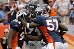 DENVER - SEPTEMBER 20:  Defensive end Elvis Dumervil #92 (L) of the Denver Broncos is congratulated by his teammates after he sacked quarterback Brady Quinn #10 of the Cleveland Browns in the fourth quarter during NFL action at Invesco Field at Mile High on September 20, 2009 in Denver, Colorado. The Broncos defeated the Browns 27-6.  (Photo by Doug Pensinger/Getty Images)