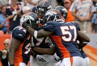 DENVER - SEPTEMBER 20:  Defensive end Elvis Dumervil #92 (L) of the Denver Broncos is congratulated by his teammates after he sacked quarterback Brady Quinn #10 of the Cleveland Browns in the fourth quarter during NFL action at Invesco Field at Mile High on September 20, 2009 in Denver, Colorado. The Broncos defeated the Browns 27-6.  (Photo by Doug Pensinger/Getty Images)