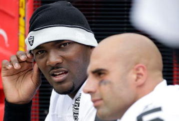 KANSAS CITY, MO - SEPTEMBER 20:  Quarterback JaMarcus Russell #2 of the Oakland Raiders talks with Bruce Gradkowski #5 on the bench during the game against the Kansas City Chiefs at Arrowhead Stadium on September 20, 2009 in Kansas City, Missouri.  (Photo by Jamie Squire/Getty Images)