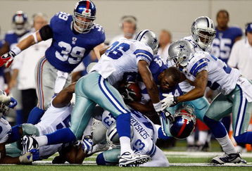 ARLINGTON, TX - SEPTEMBER 20:  Running back Ahmad Bradshaw #44 of the New York Giants is tackled by Ken Hamlin #26 and Orlando Scandrick #32 of the Dallas Cowboys at Cowboys Stadium on September 20, 2009 in Arlington, Texas.  (Photo by Ronald Martinez/Getty Images)