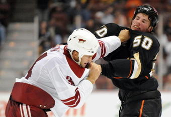 ANAHEIM, CA - SEPTEMBER 16:  Troy Bodie #50 of the Anaheim Ducks fights with Daniel Winnik #34 of the Phoenix Coyotes during the second period at Honda Center on September 16, 2009 in Anaheim, California.  (Photo by Harry How/Getty Images)
