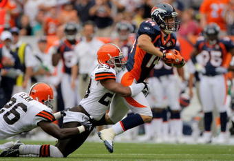 DENVER - SEPTEMBER 20:  Wide reciever Brandon Stokley #14 of the Denver Broncos makes a 47 yard reception and is tackled by Hank Poteat #23 of the Cleveland Browns during NFL action at Invesco Field at Mile High on September 20, 2009 in Denver, Colorado.  (Photo by Doug Pensinger/Getty Images)