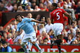 MANCHESTER, ENGLAND - SEPTEMBER 20:  Carlos Tevez of Manchester City competes for the ball with Rio Fedinand of Manchester United during the Barclays Premier League match between Manchester United and Manchester City at Old Trafford on September 20, 2009 in Manchester, England.  (Photo by Alex Livesey/Getty Images)