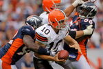 DENVER - SEPTEMBER 20:  Quarterback Brady Quinn #10 of the Cleveland Browns is sacked by defensive end Elvis Dumervil #92 of the Denver Broncos as linebacker Robert Ayers looks to help out in the fourth quarter during NFL action at Invesco Field at Mile High on September 20, 2009 in Denver, Colorado. The Broncos defeated the Browns 27-6.  (Photo by Doug Pensinger/Getty Images)
