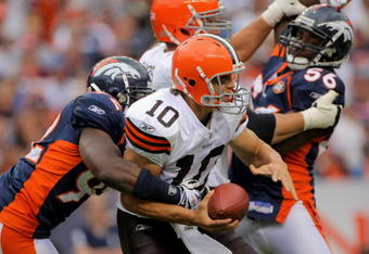 DENVER - SEPTEMBER 20:  Quarterback Brady Quinn #10 of the Cleveland Browns is sacked by defensive end Elvis Dumervil #92 of the Denver Broncos as linebacker Robert Ayers looks to help out in the fourth quarter during NFL action at Invesco Field at Mile High on September 20, 2009 in Denver, Colorado. The Broncos defeated the Browns 27-6.  (Photo by Doug Pensinger/Getty Images)