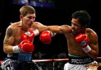 LAS VEGAS - MAY 02:  (R-L) Manny Pacquiao of the Philippines throws a right to the face of Ricky Hatton of England in the first round of their junior welterweight title fight at the MGM Grand Garden Arena May 2, 2009 in Las Vegas, Nevada. Pacquiao defeated Hatton by 2nd round TKO. (Photo by Al Bello/Getty Images)